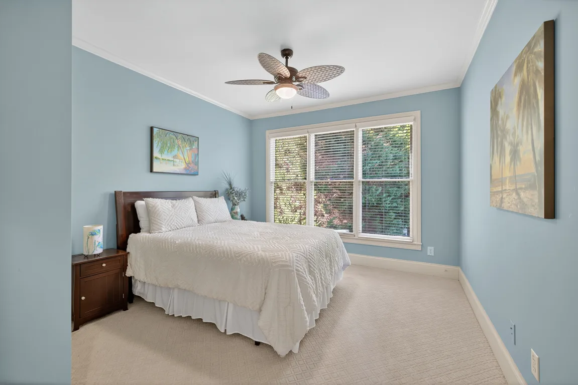 Secondary bedroom with light blue walls and white trim