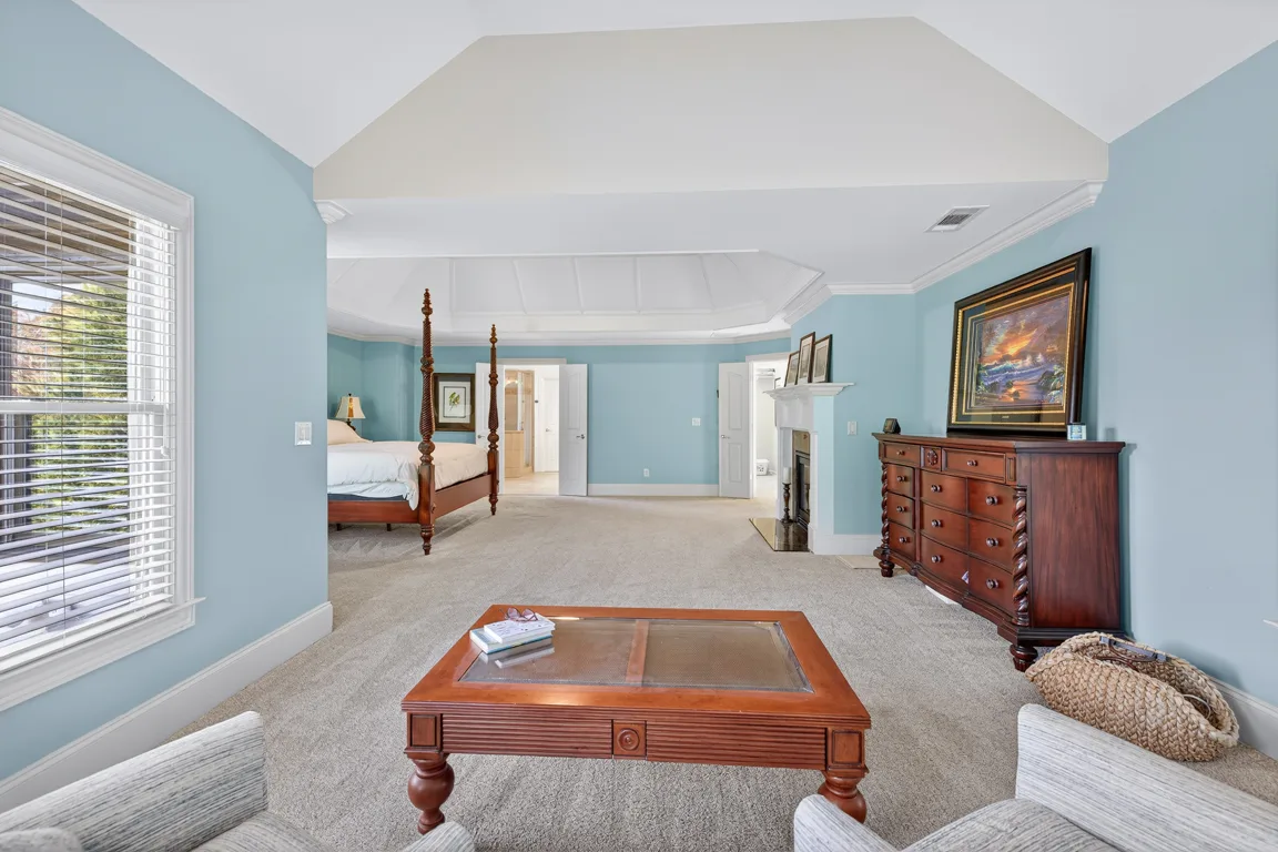 Master bedroom with sitting area and stone fireplace