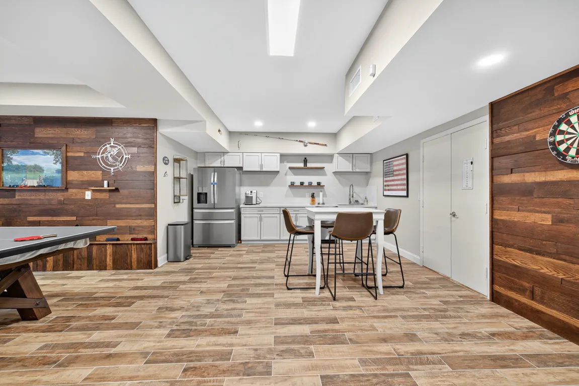 Basement recreation room with pool table and kitchenette