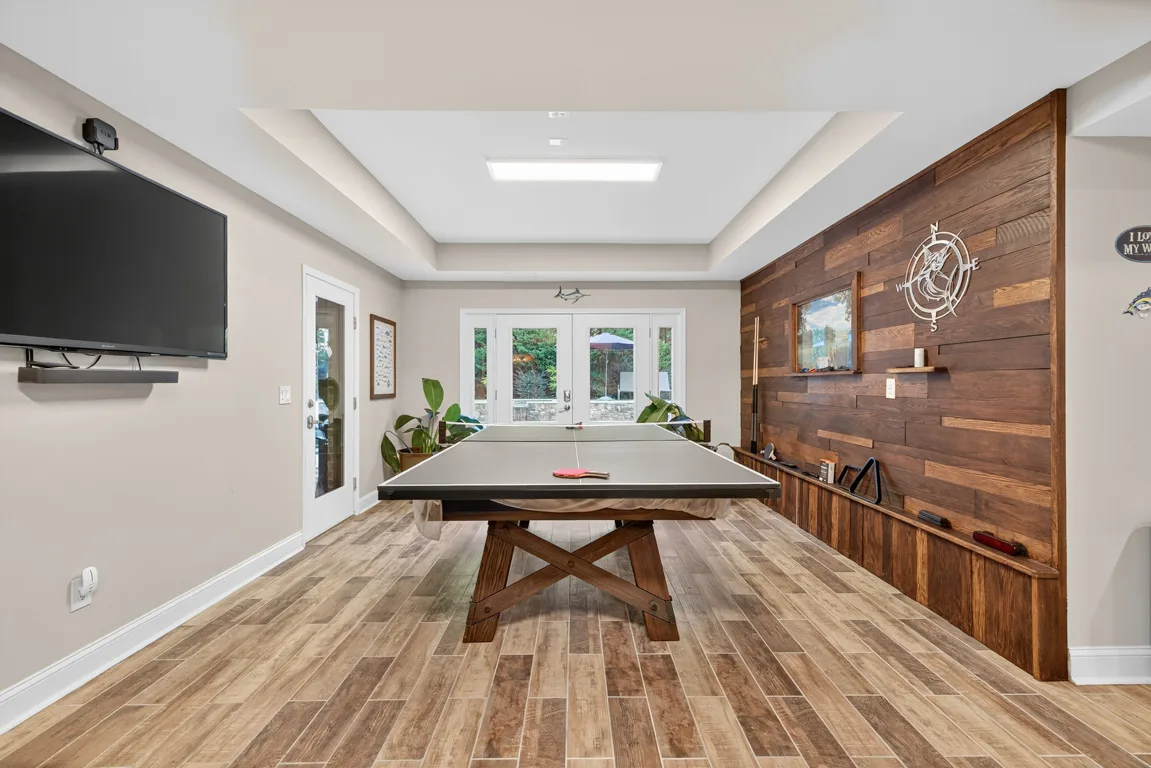 Recreation room with ping pong table and wood accent wall