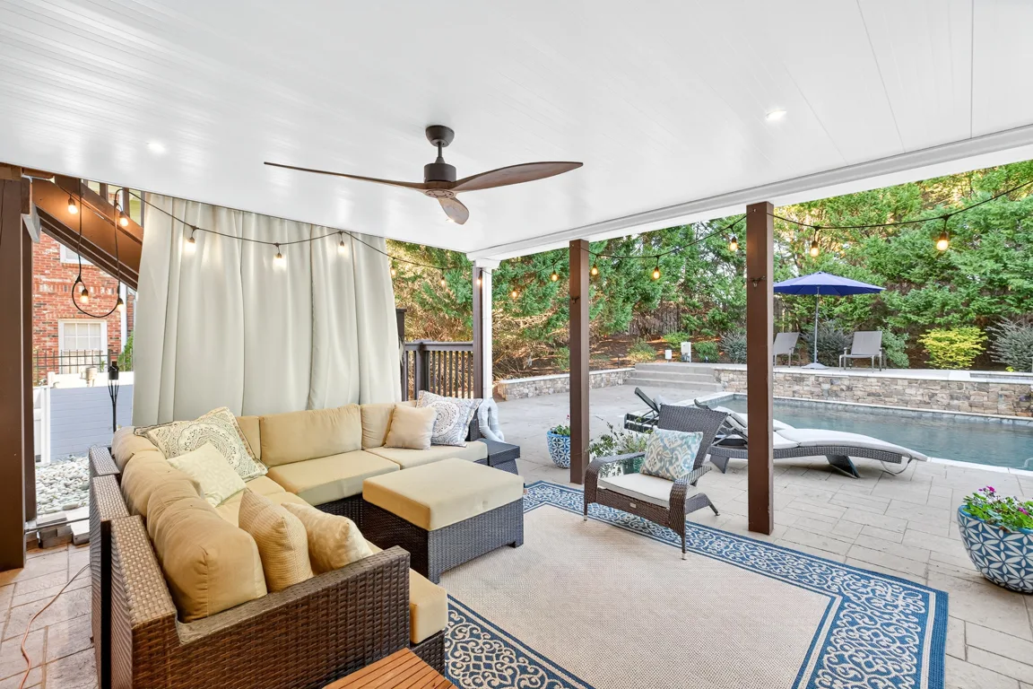 Covered patio lounge overlooking the pool