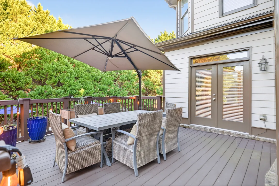 Elevated wooden deck with railing and ceramic planters
