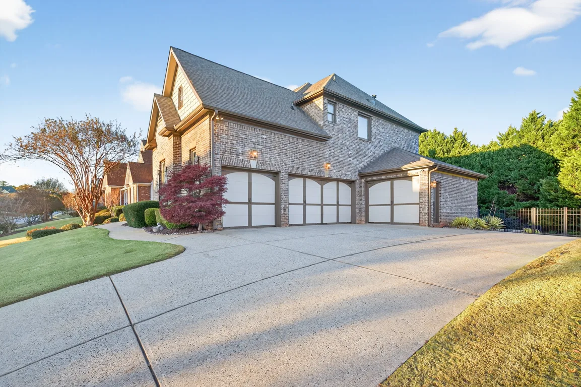 Side profile with driveway and 4-car garage bay