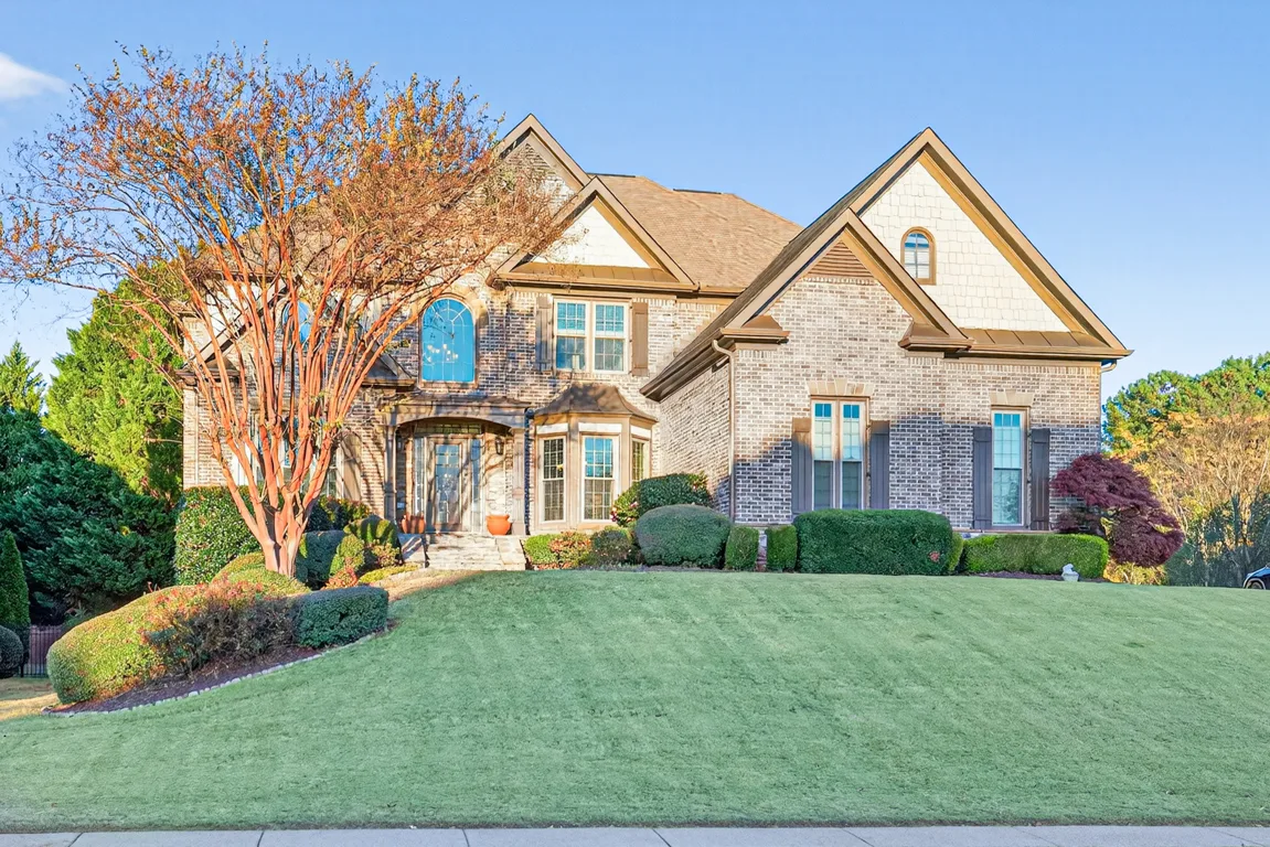 Front facade at golden hour with mature tree and manicured lawn