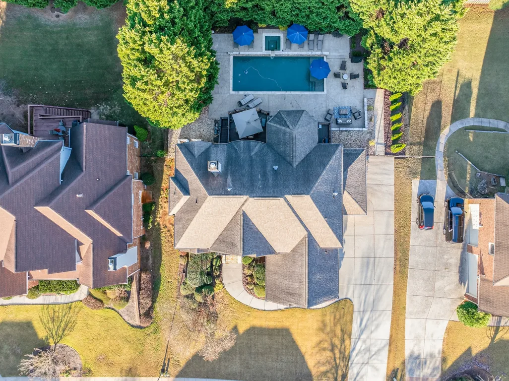 Aerial top-down view showing pool, spa, deck, and patio layout