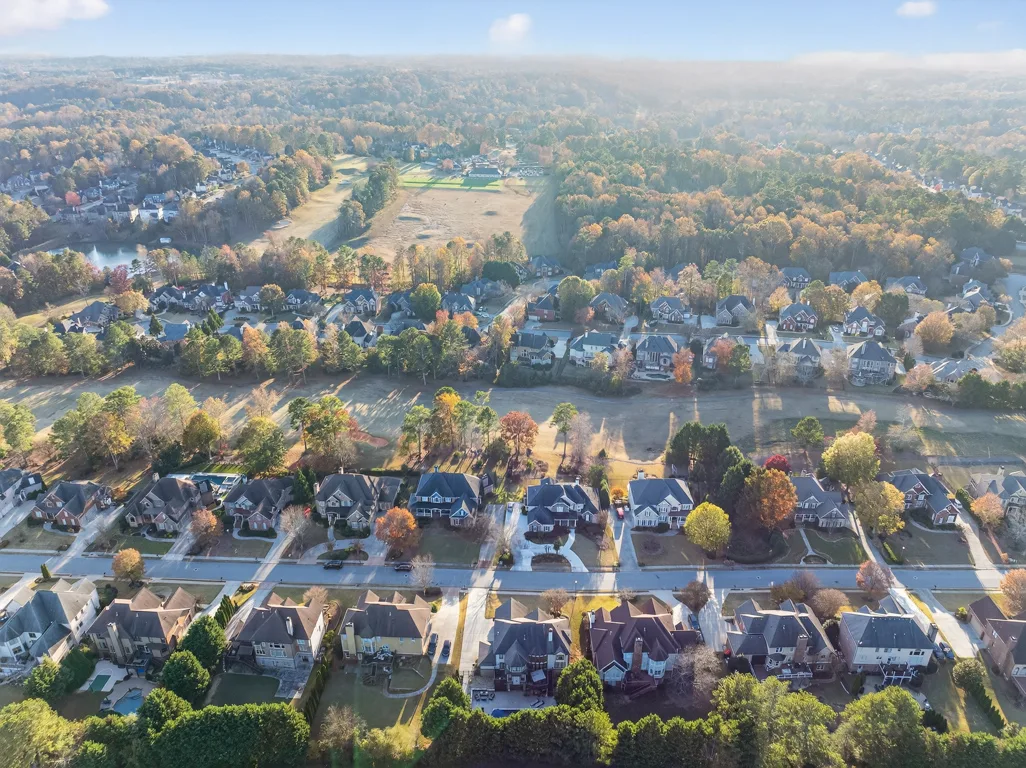 Aerial drone shot across the residential neighborhood in autumn