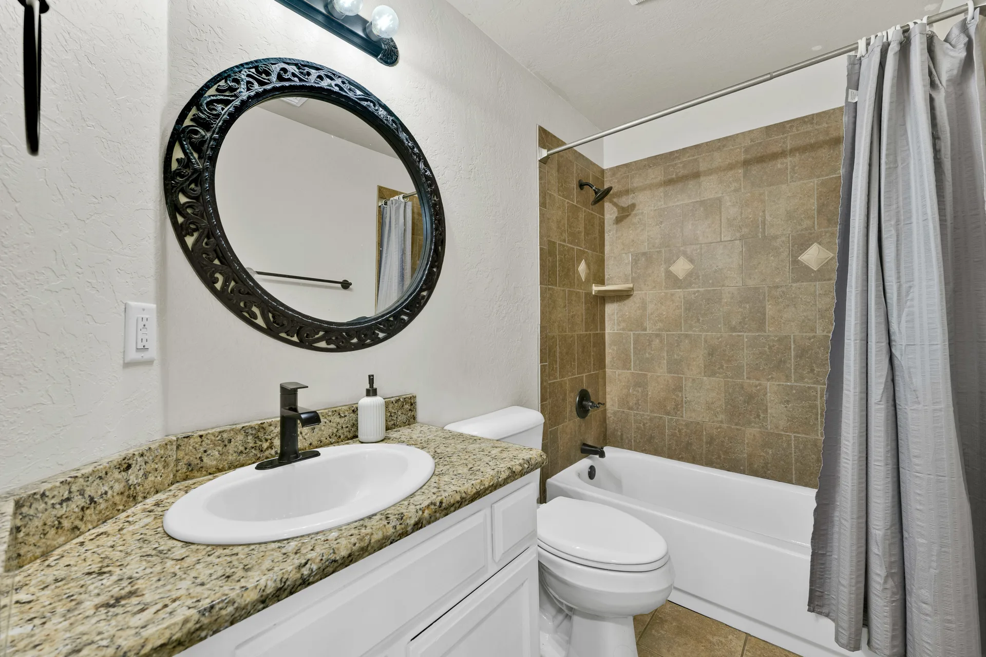 Guest bathroom with vanity area and tub-shower combo