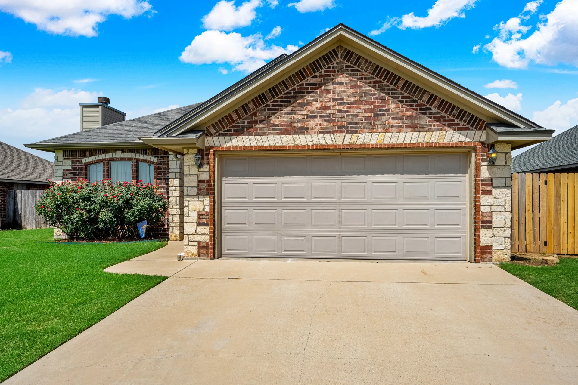 Front exterior of 408 Mountain Meadow Dr, Cache OK — brick veneer and stone accents with manicured lawn