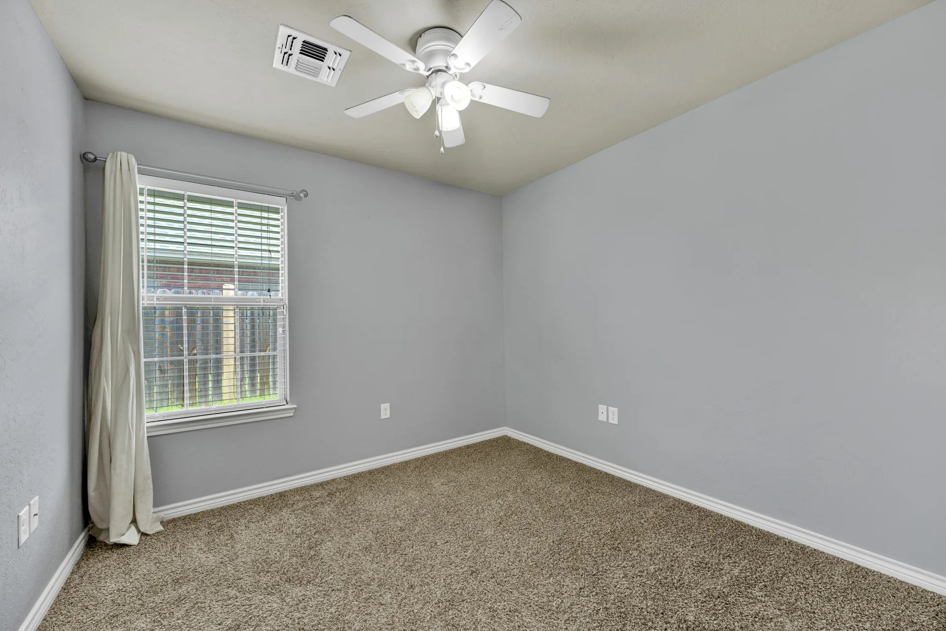 Bedroom with natural light from window and carpet flooring