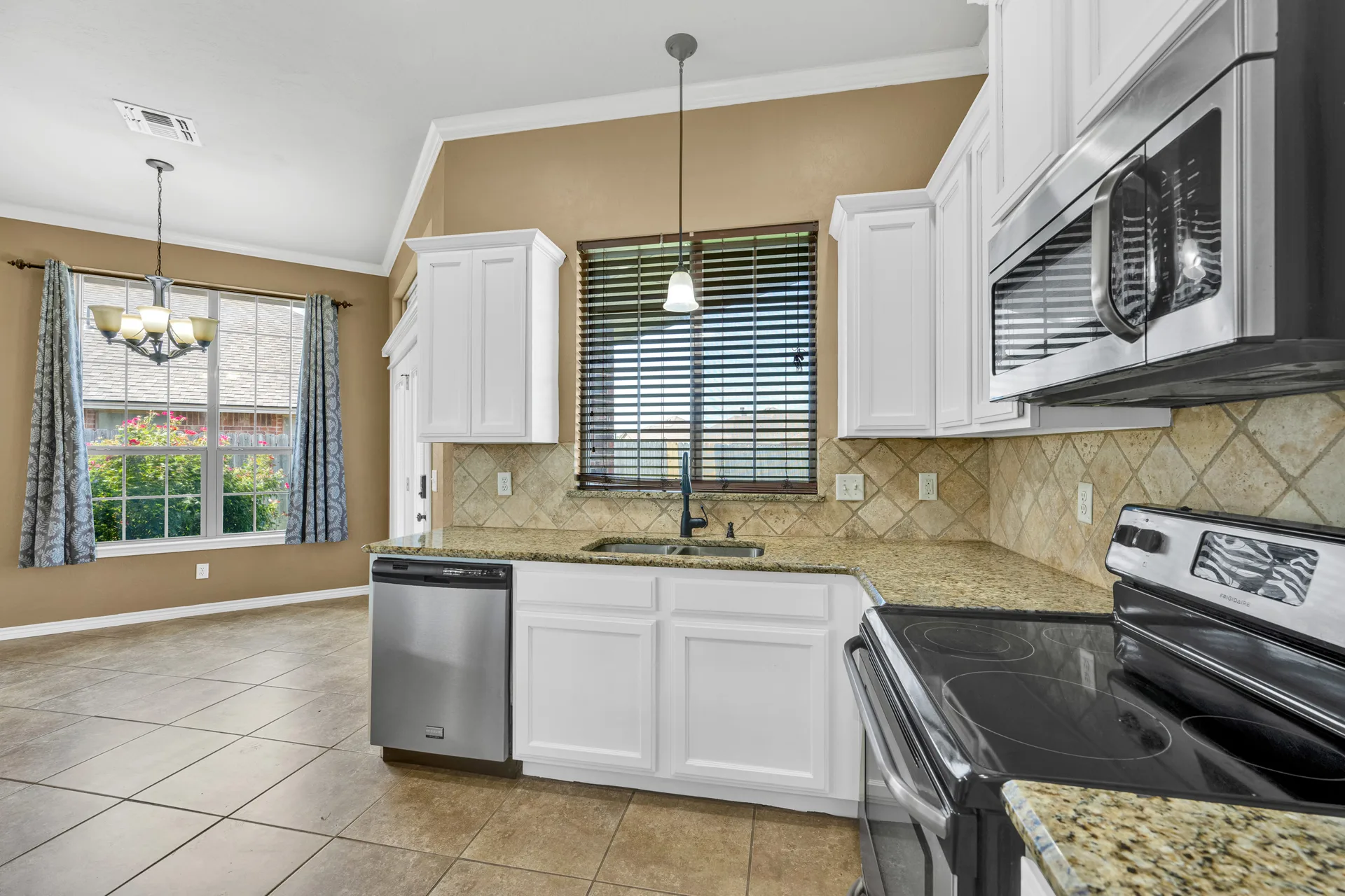 Kitchen with open plan dining area and tile backsplash