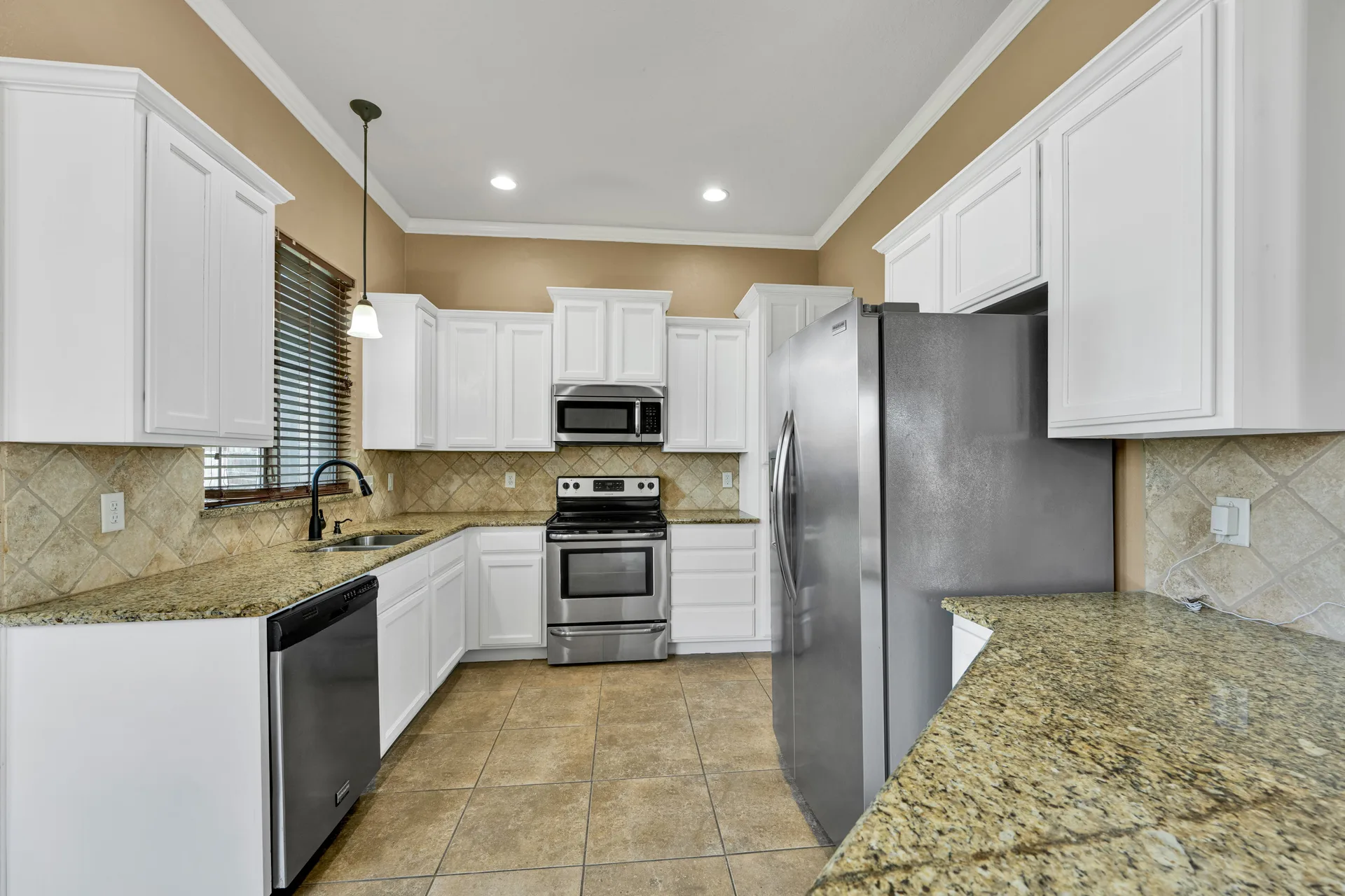 U-shaped kitchen with white raised-panel cabinets