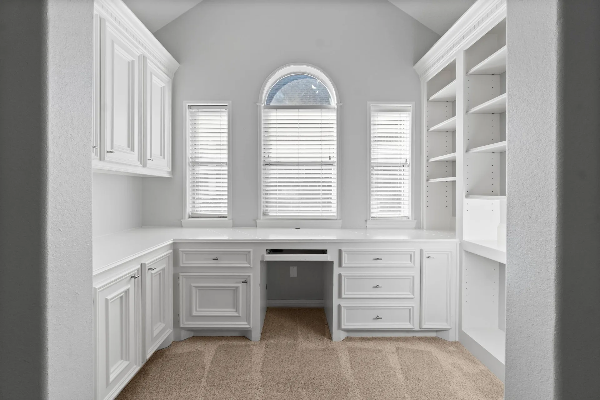 Study with custom white cabinetry and built-in desk area
