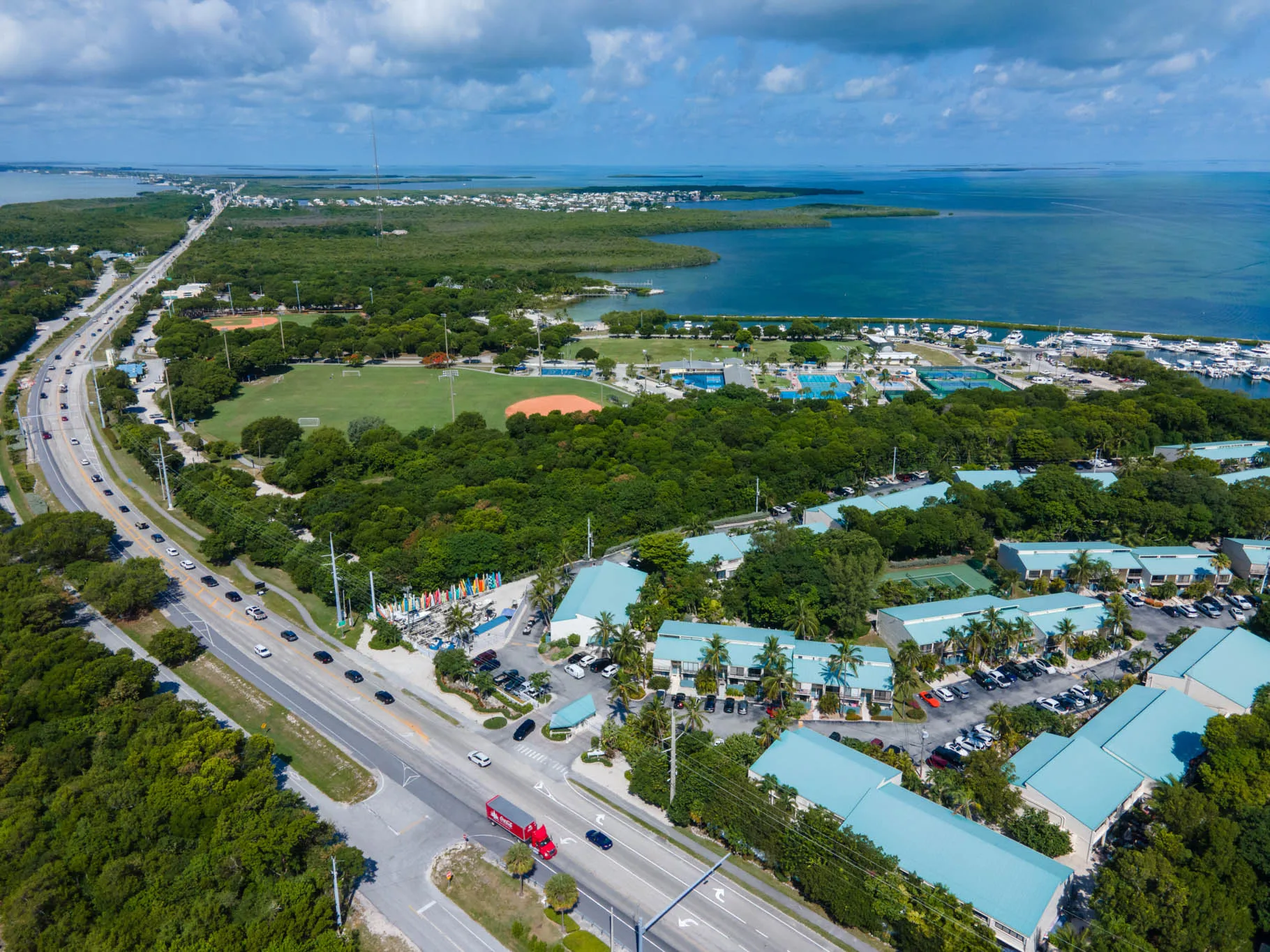 Wide aerial showing community layout and surrounding water