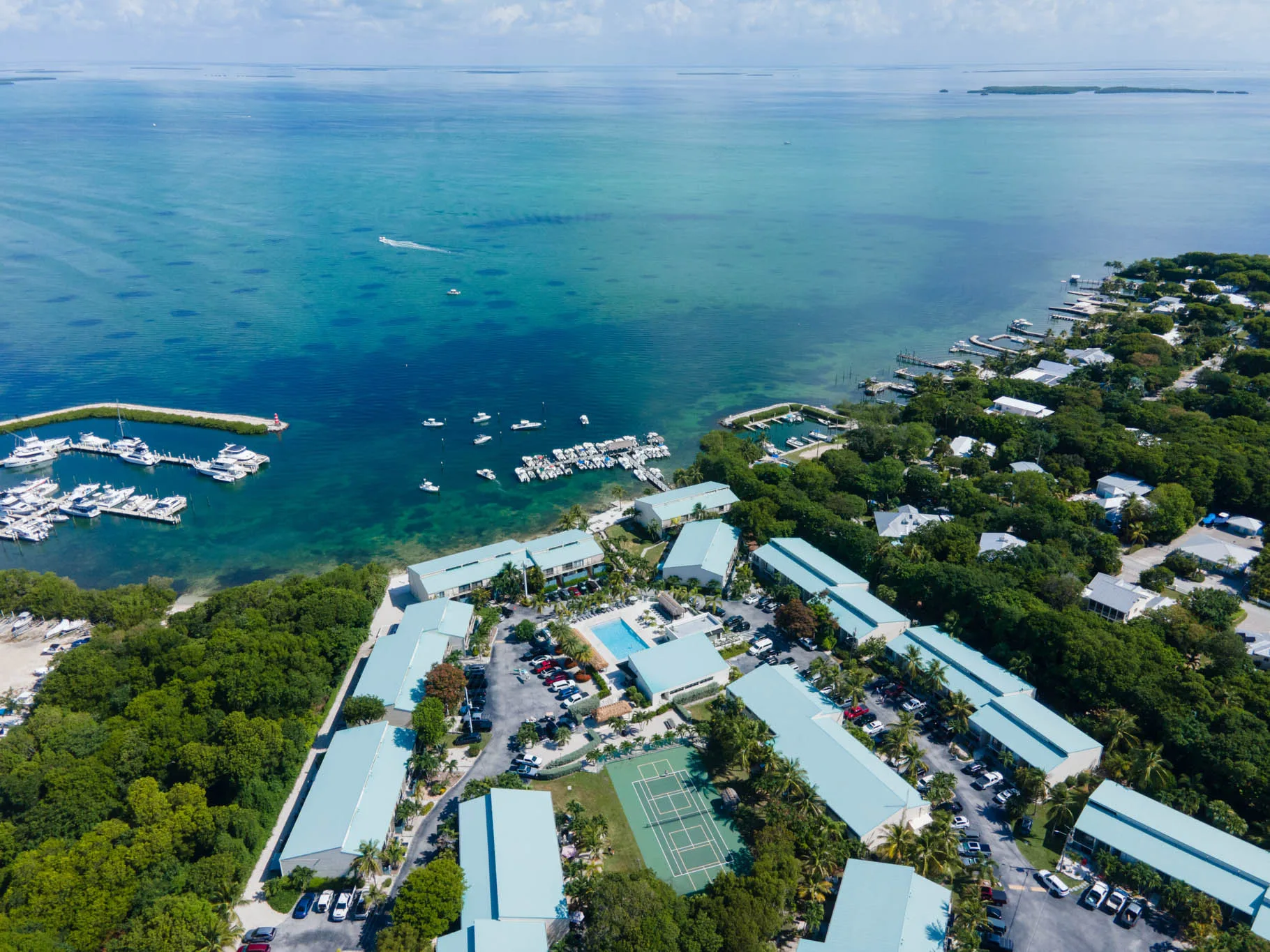 Executive Bay Club with marina, pool, and bay views