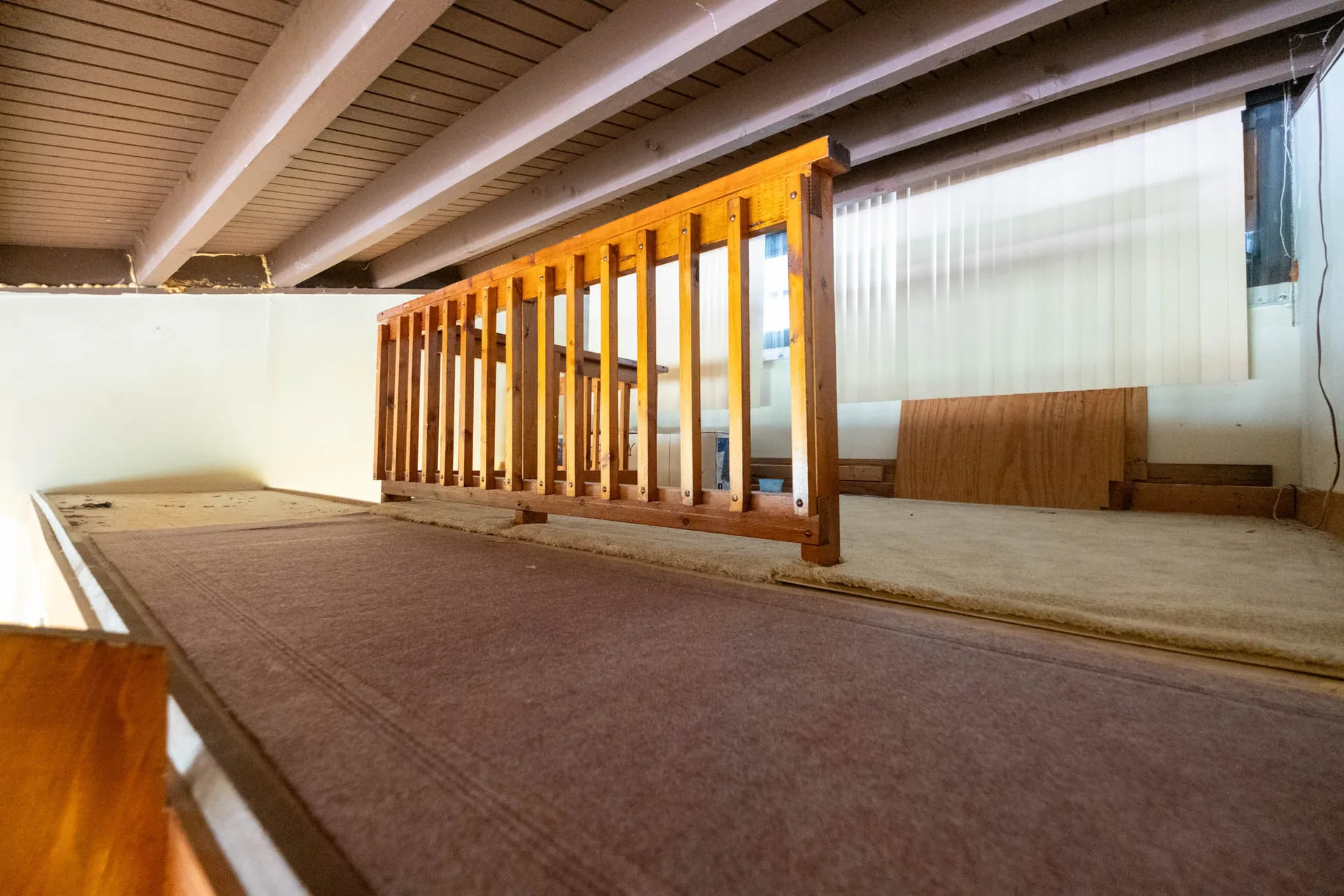 Lofted mezzanine space with rustic wood beams