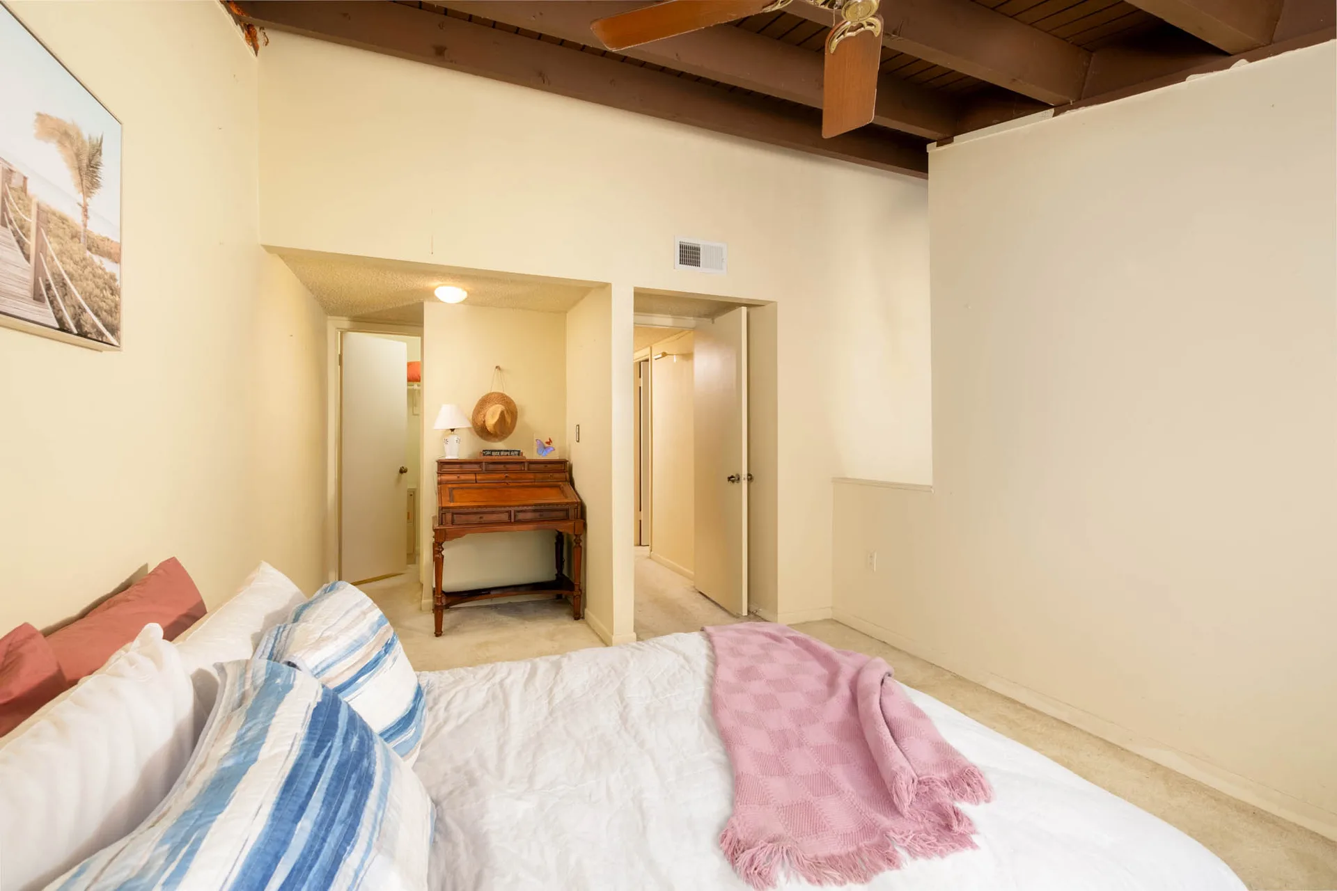 Master bedroom with vaulted ceilings and natural light