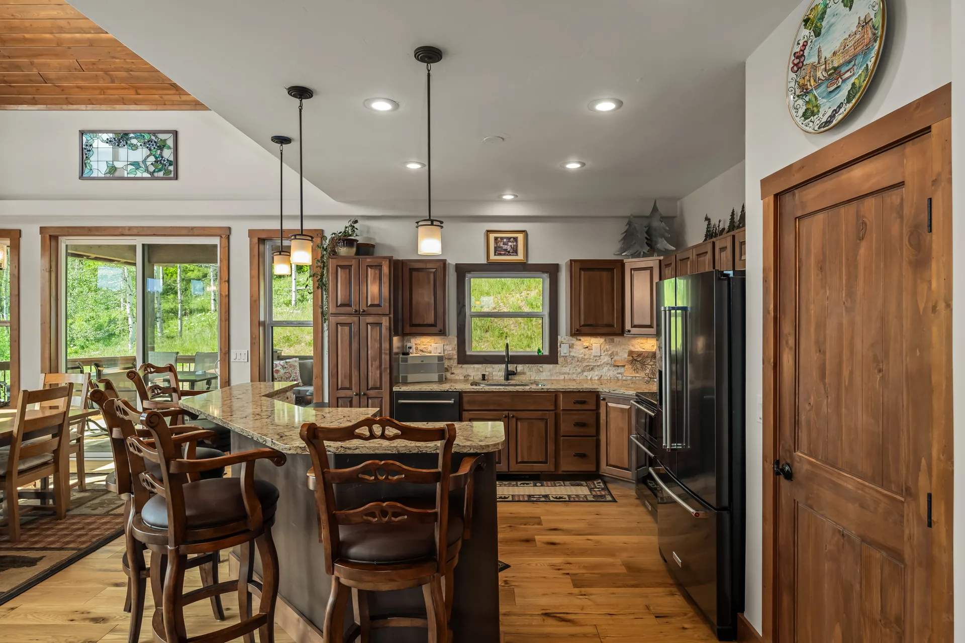 Rustic kitchen with quartz countertops and stone backsplash