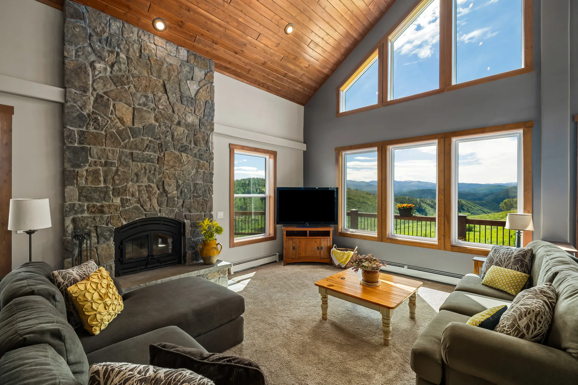 Living room with floor-to-ceiling stone fireplace