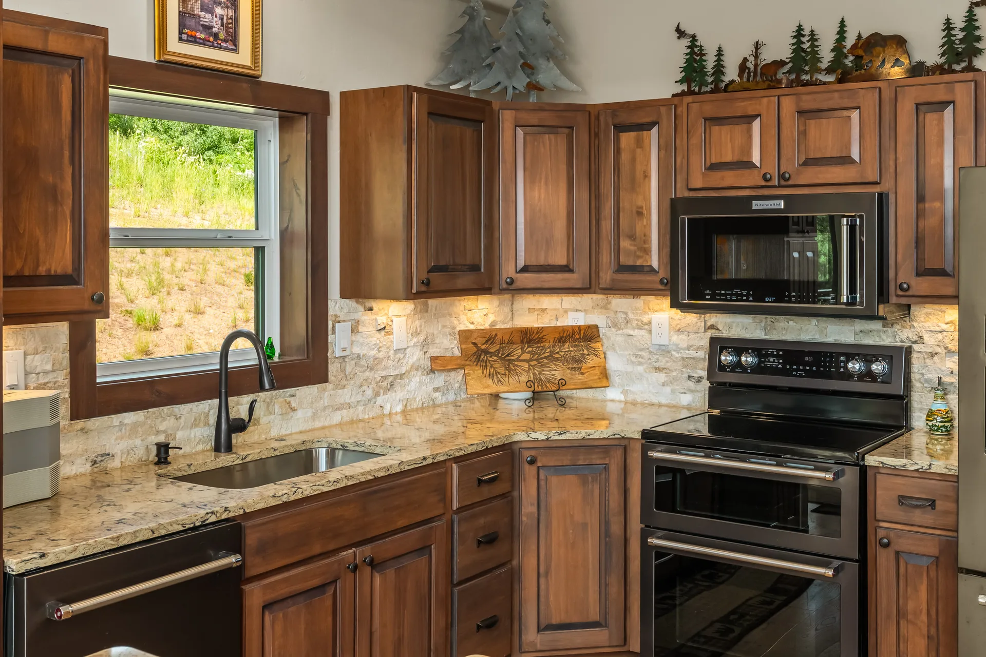 Kitchen vignette with stone veneer backsplash and warm wood tones