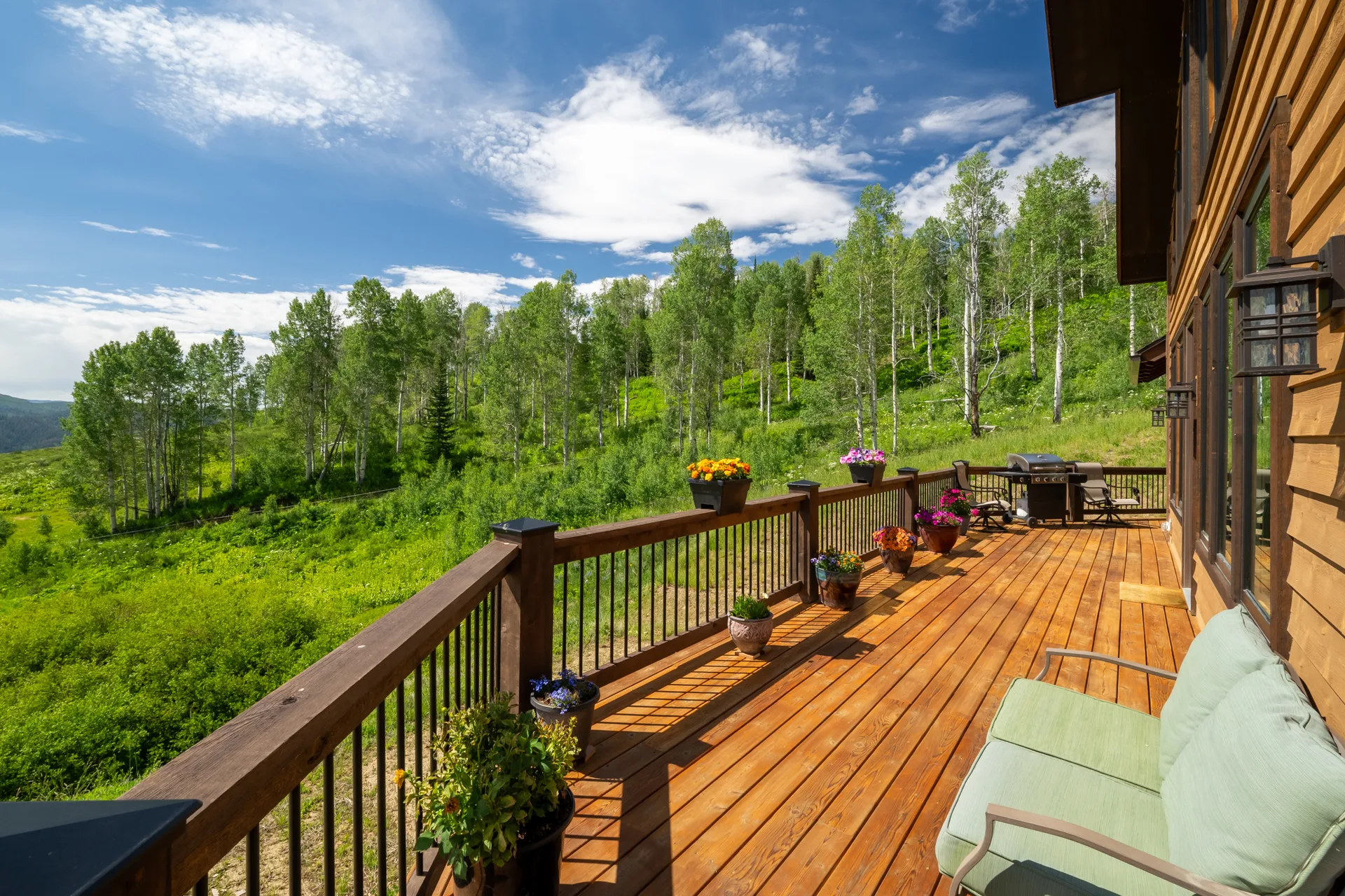 Expansive deck with mountain vistas and natural wood siding