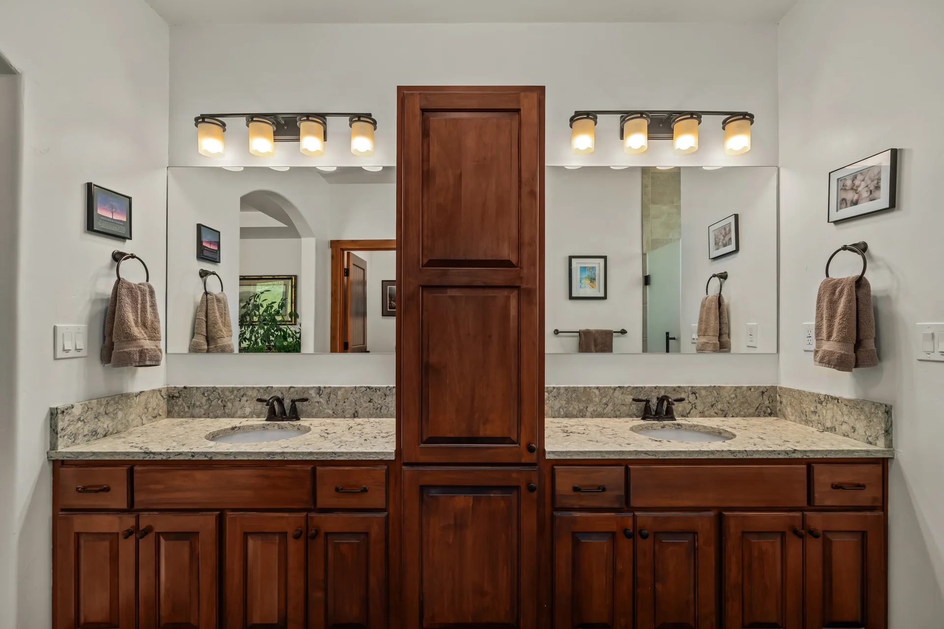 Bathroom with double vanity and dark wood cabinetry