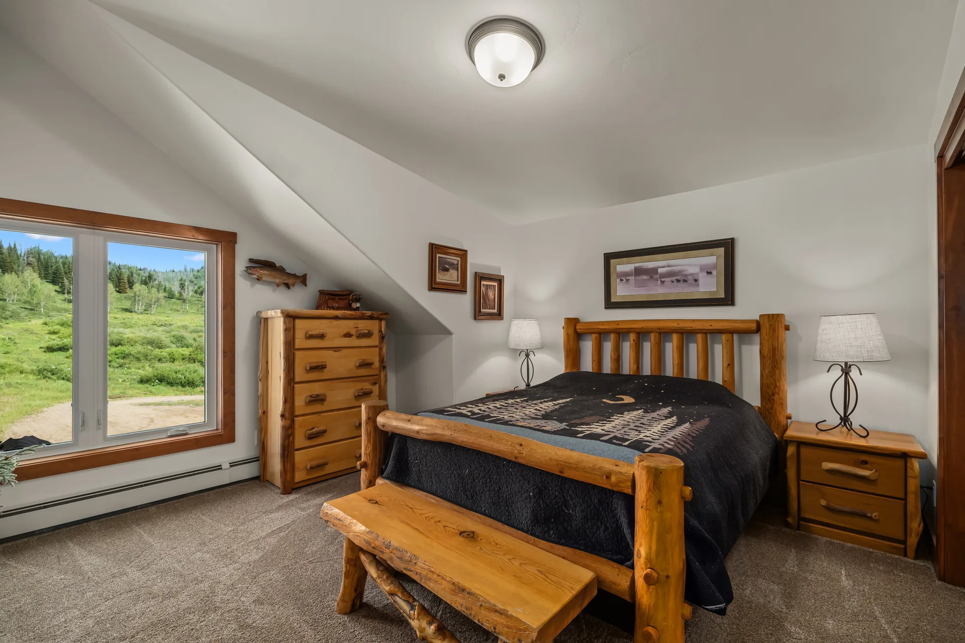 Rustic bedroom with log-style bed frame and mountain views