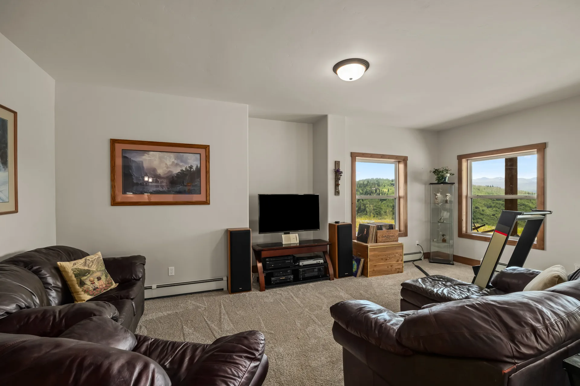 Living room with large windows framing mountain views