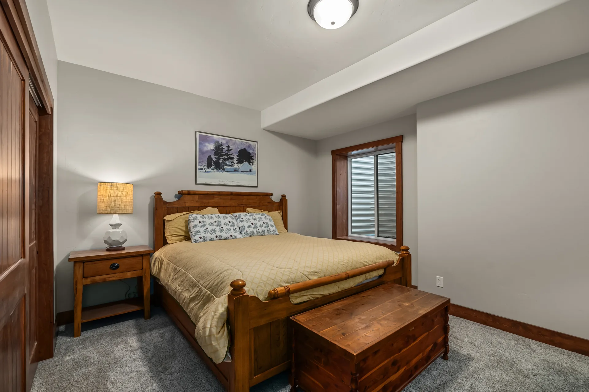 Secondary bedroom with wooden furniture and light walls