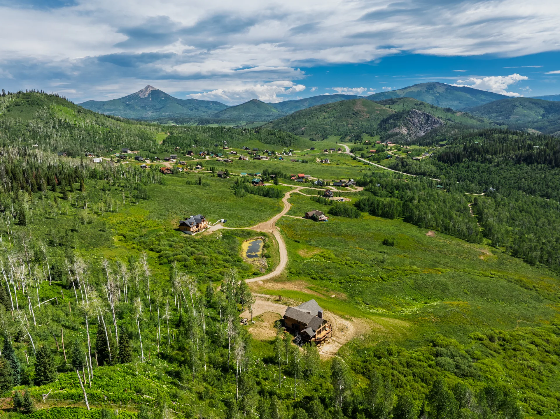 Drone aerial view of mountain property with surrounding terrain