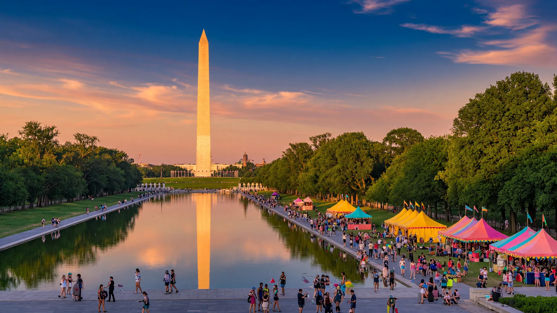 The Washington Monument and National Mall at golden hour during a festive DC summer evening