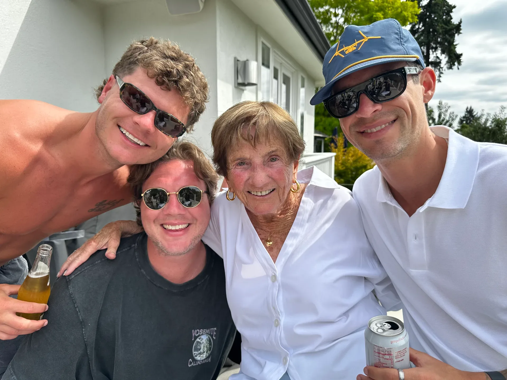 Sharon with three younger men in an outdoor group photograph