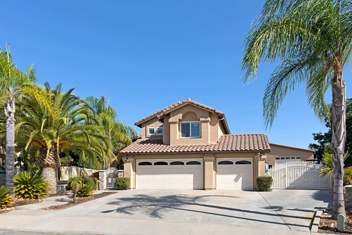 Two-story home in Murrieta with palm trees and blue sky