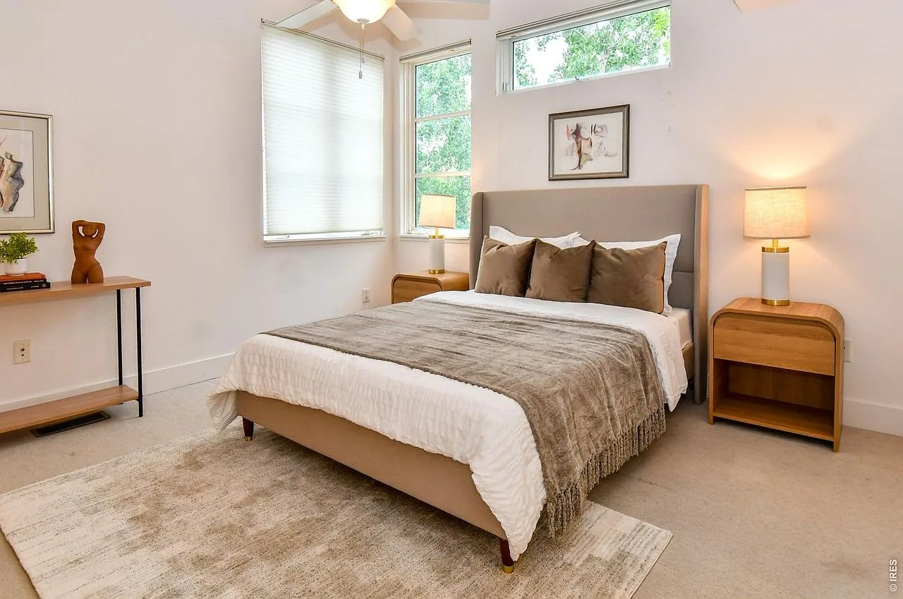Serene master bedroom with neutral tones and natural daylight
