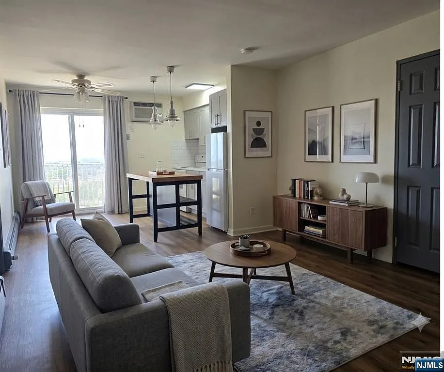 Renovated open-concept living and kitchen area with new flooring