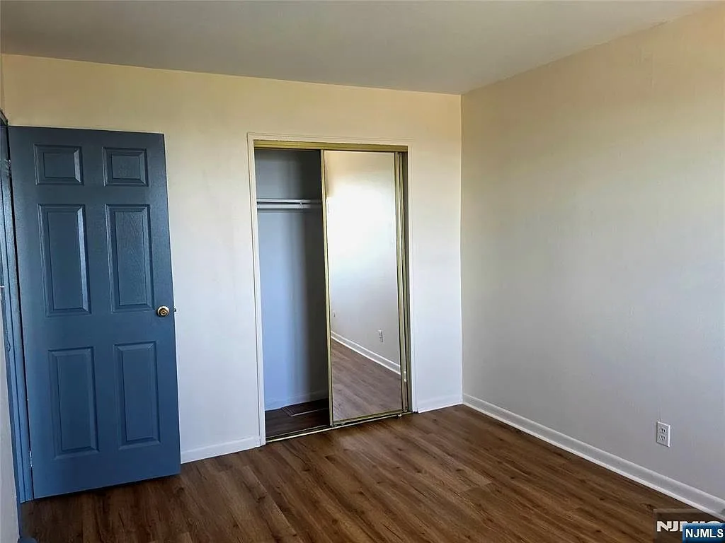Bedroom with closet door and new flooring