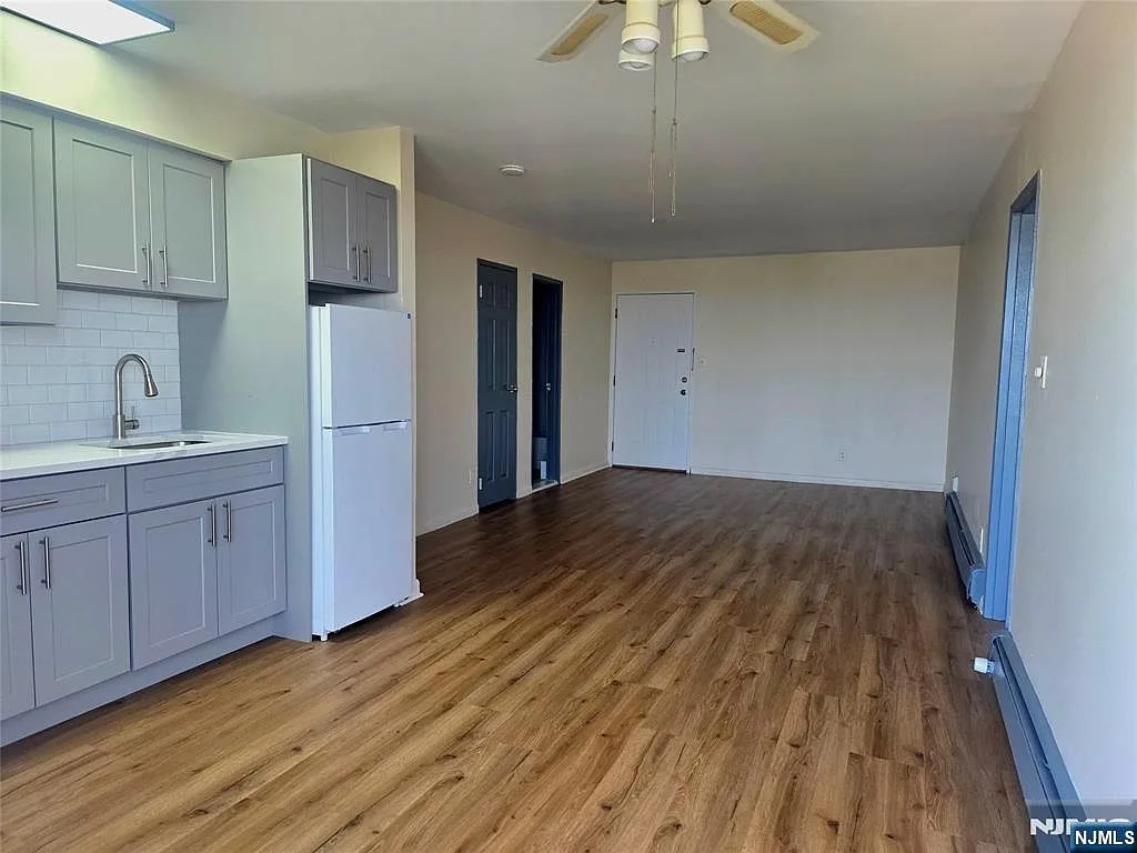Open-concept kitchen and living area with new high-grade laminate flooring
