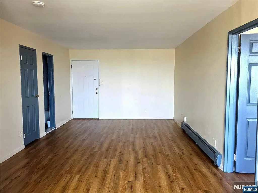 Living room entry view with new wide-plank flooring