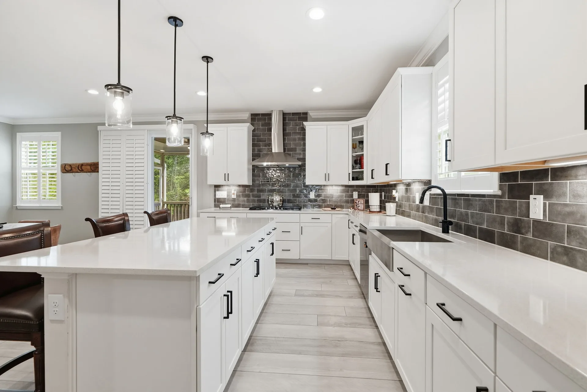 Modern farmhouse kitchen with white Shaker cabinets, farmhouse sink, and quartz countertops