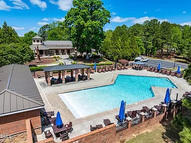 Aerial view of the Portofino community pool with brick clubhouse and pool deck