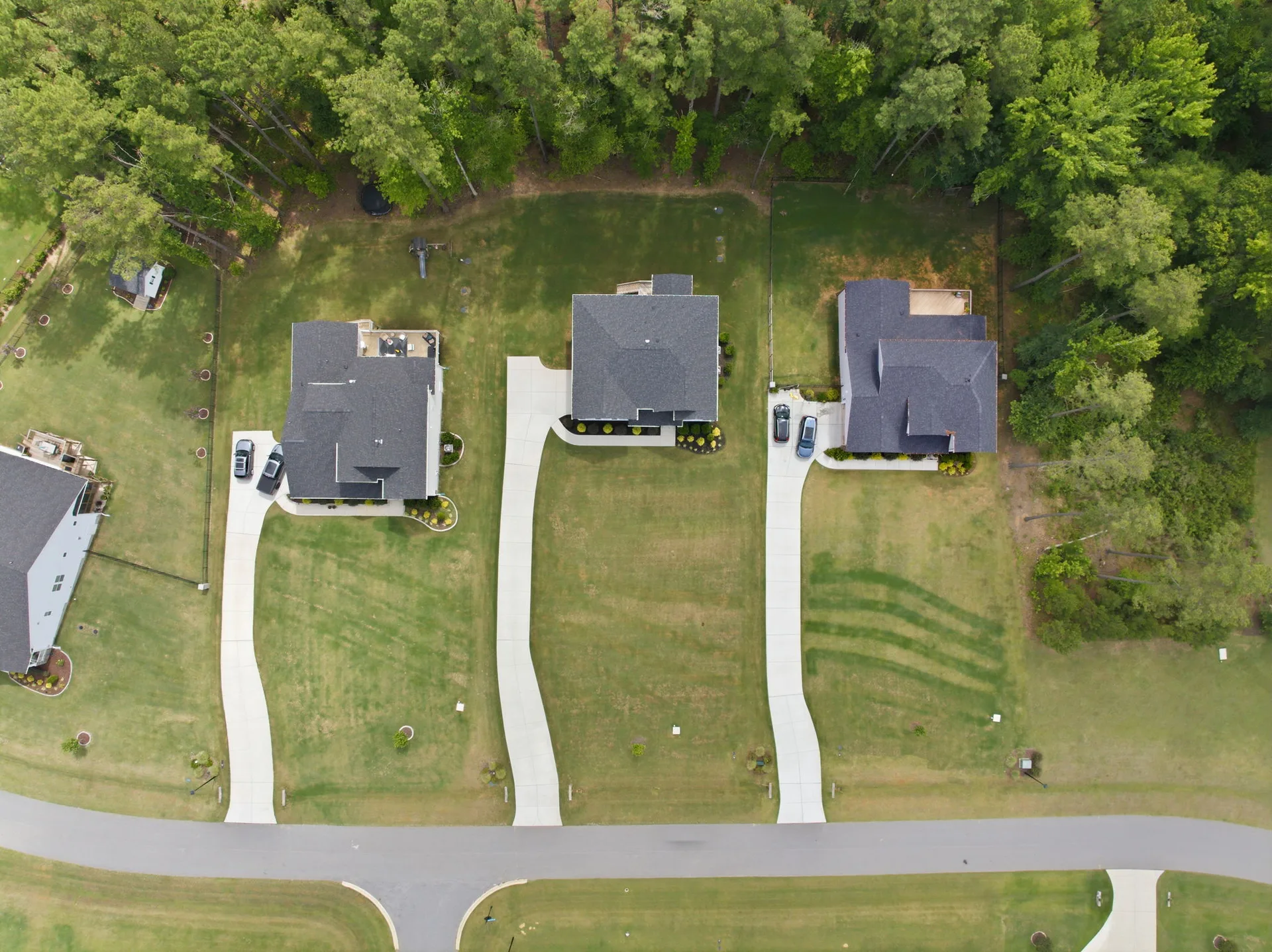 Drone aerial looking straight down at the residential street and backyards