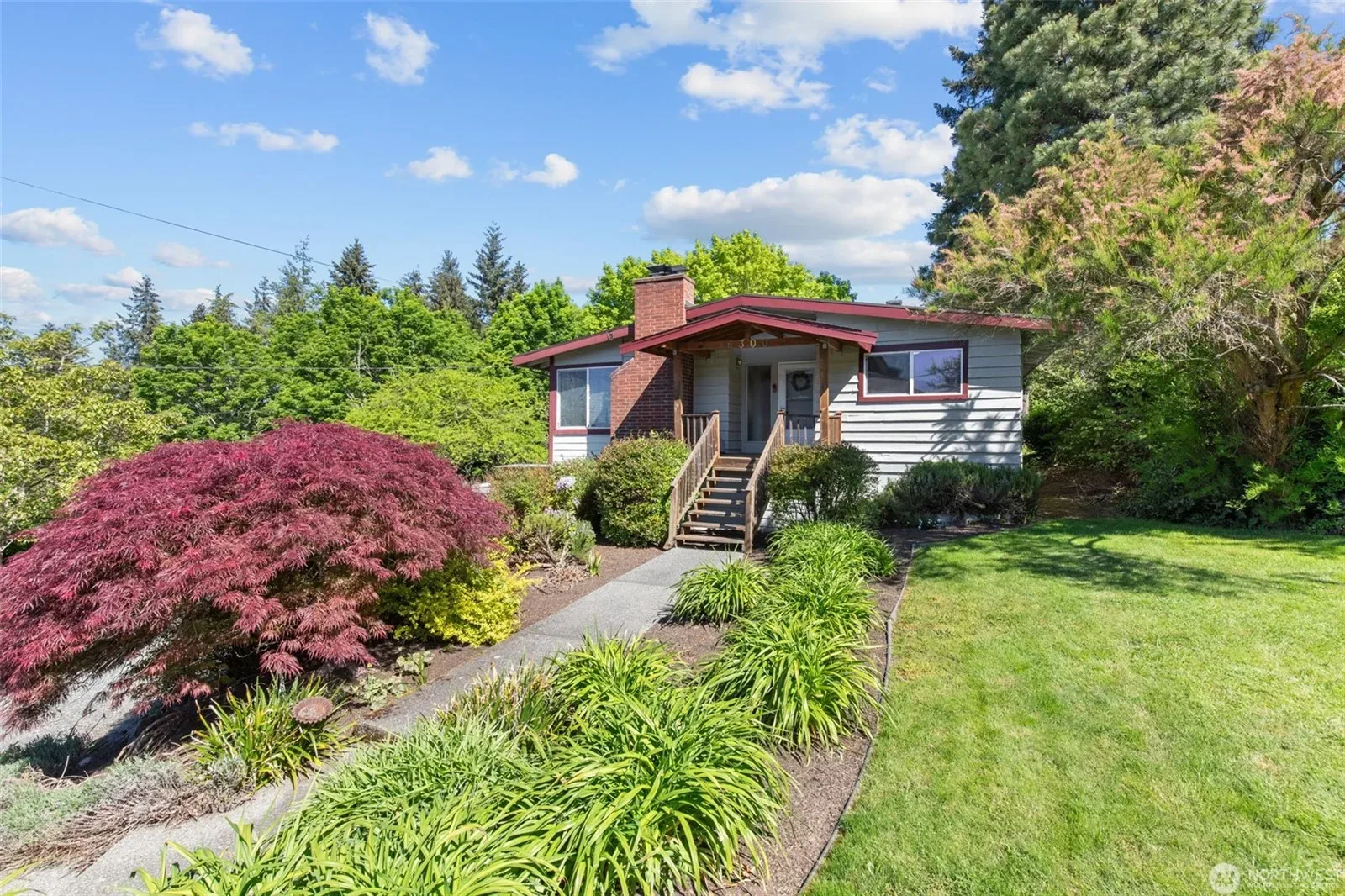 Exterior of Matt and Lisa's ranch-style home, freshly prepared and beautifully landscaped for sale