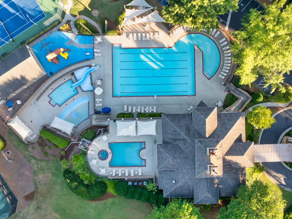 Drone overhead view of the Apalachee Farms recreational complex with pools, tennis courts, splash pad, and clubhouse