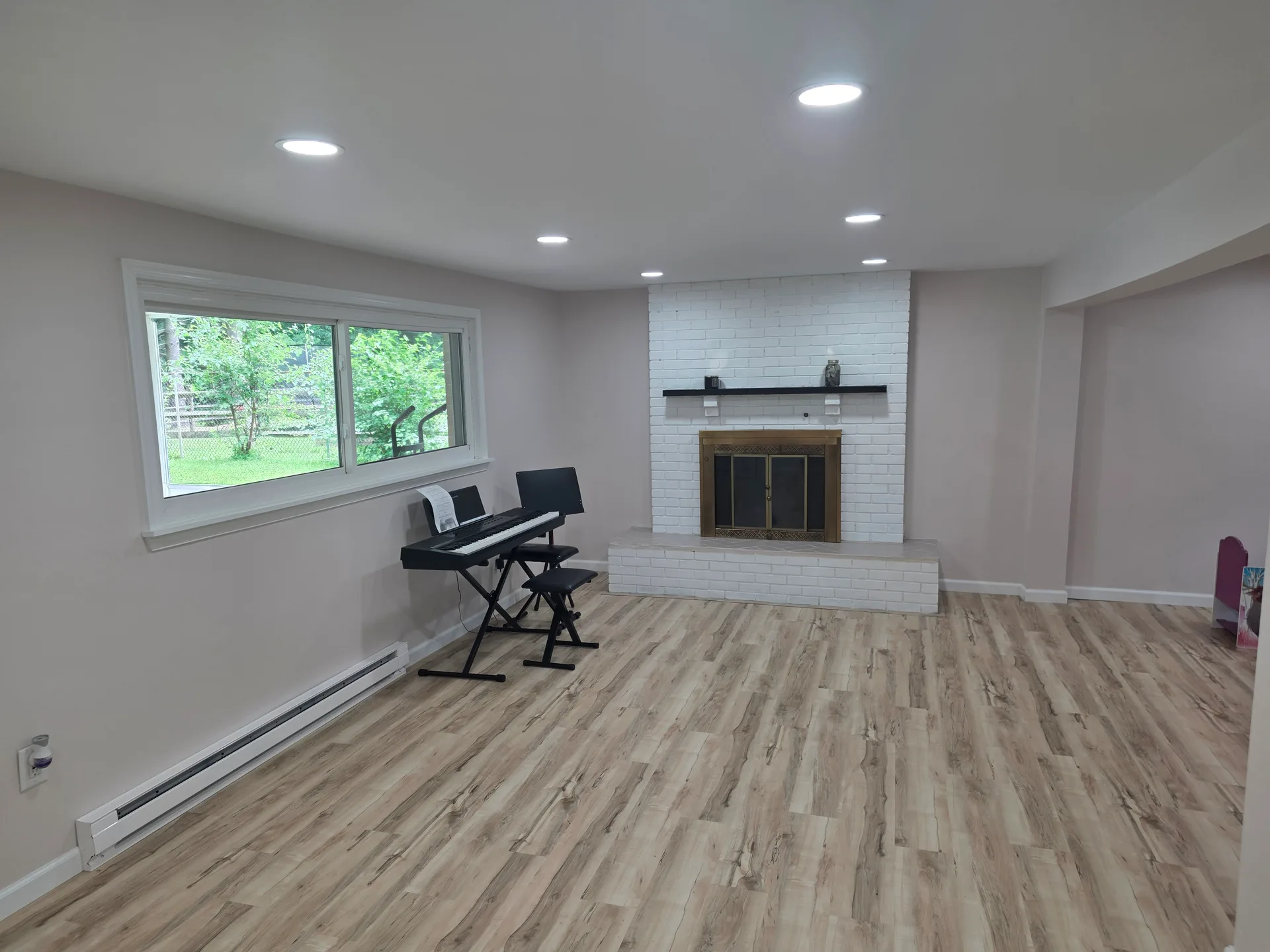 Lower level family room with fireplace and laminate flooring