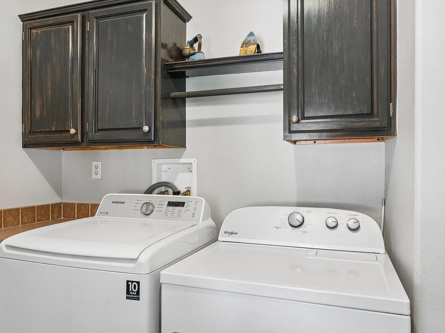 Laundry utility room with dark cabinetry