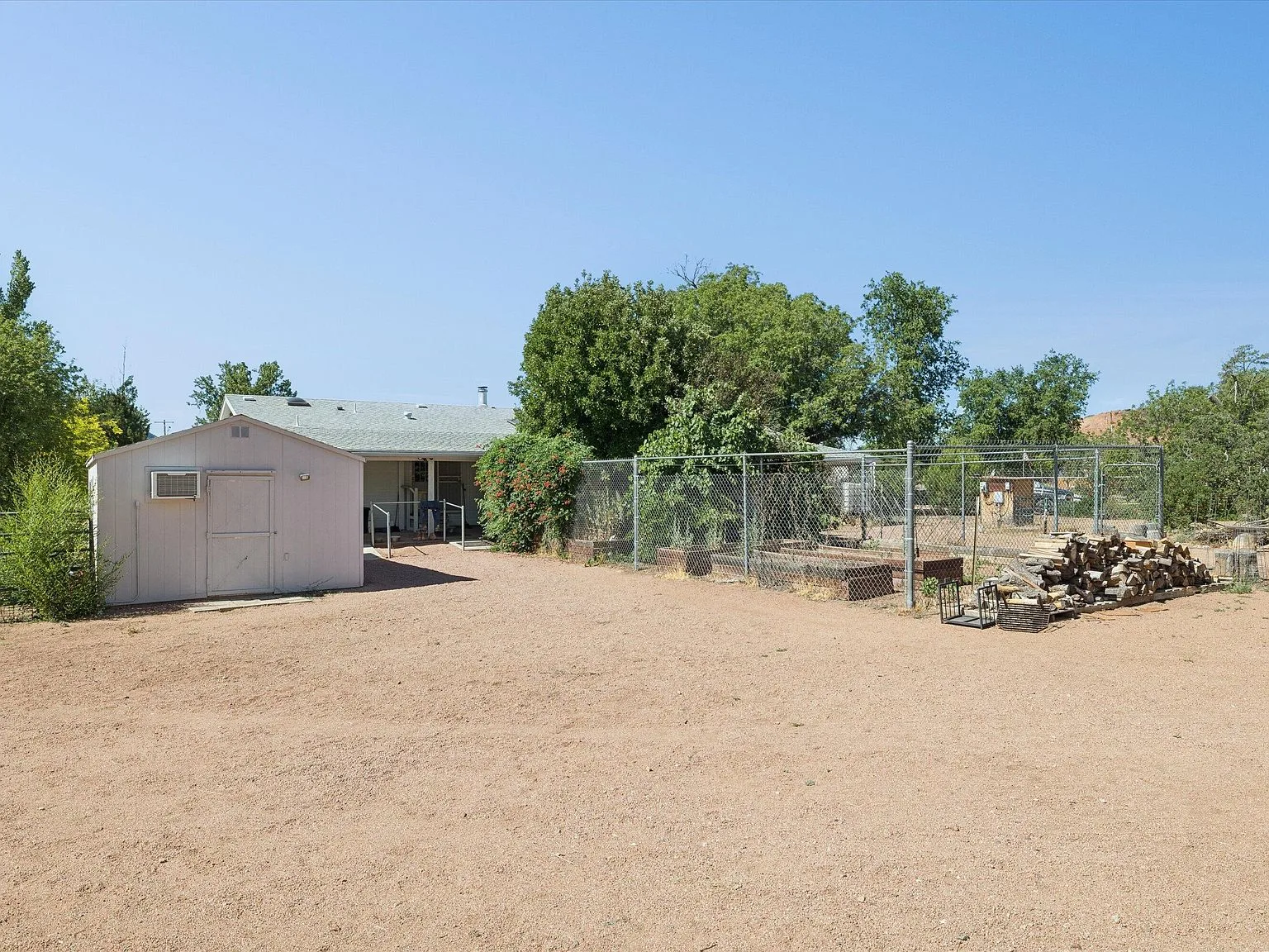 Backyard storage area and fenced garden