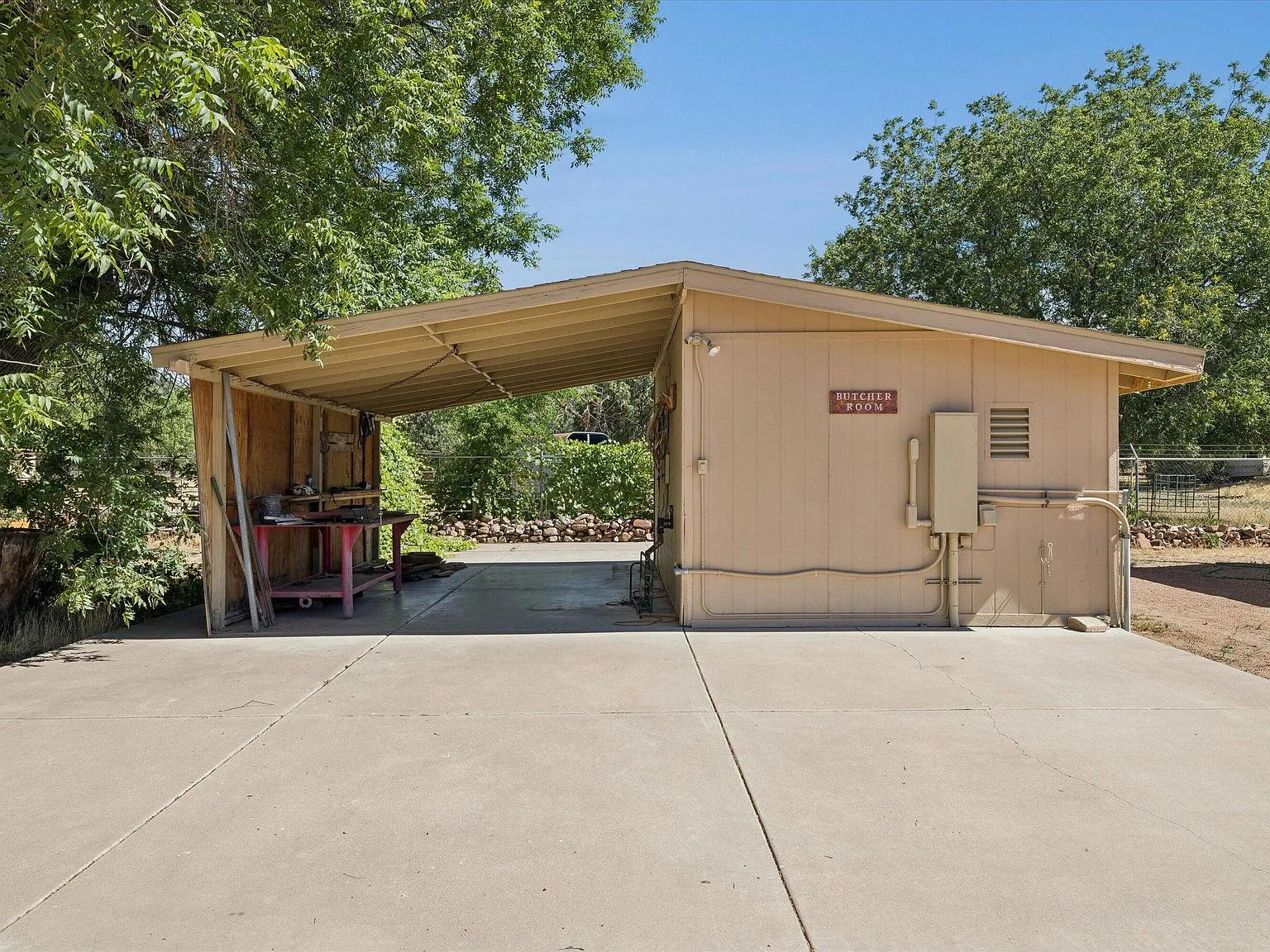Standalone butcher prep building with carport