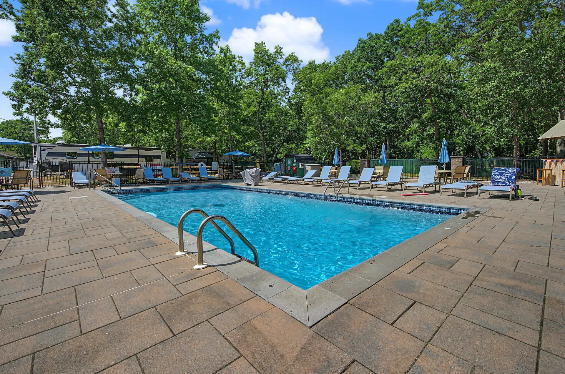 Community swimming pool with lounge chairs