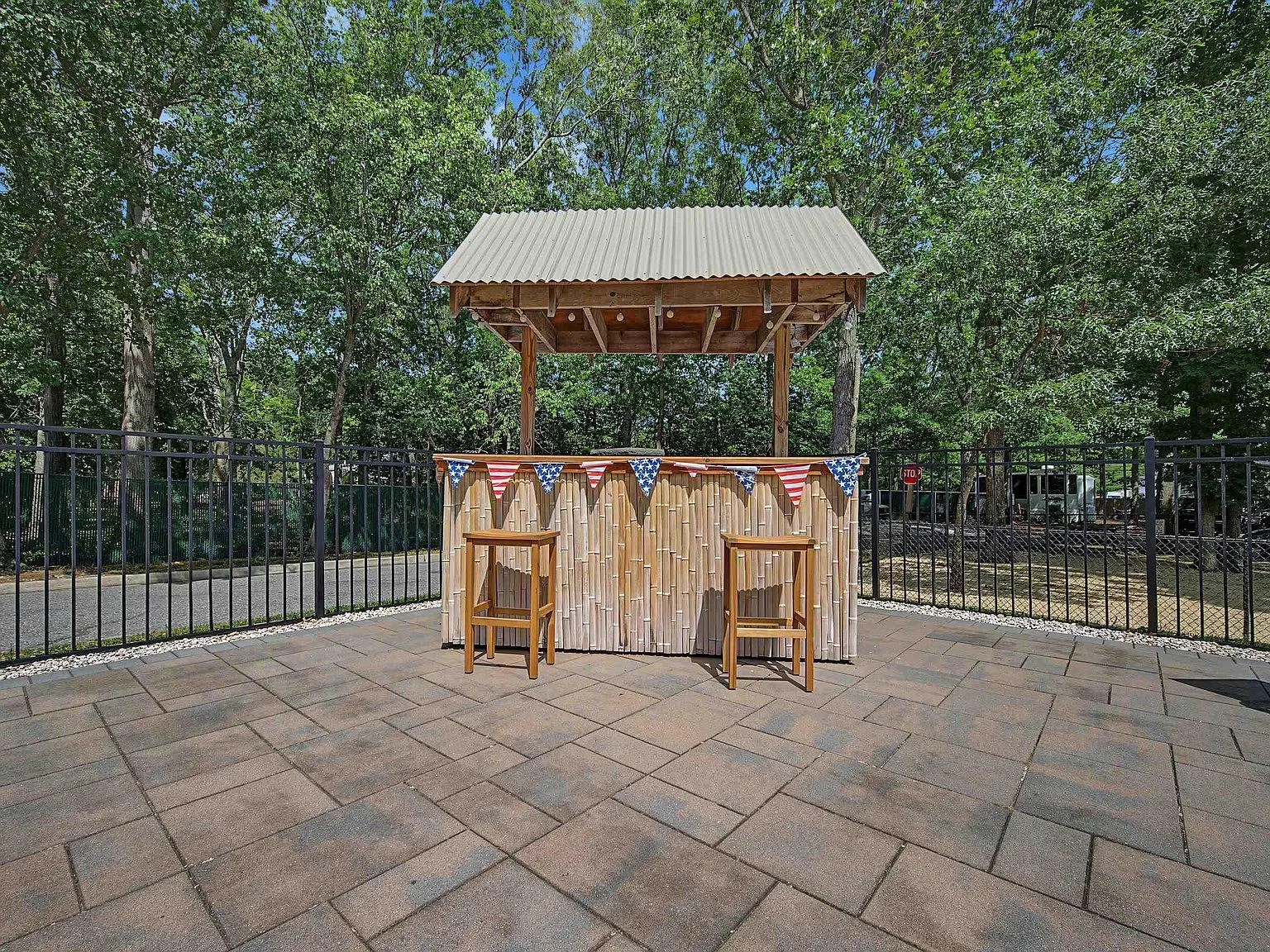 Outdoor bar area with bamboo bar on paver patio