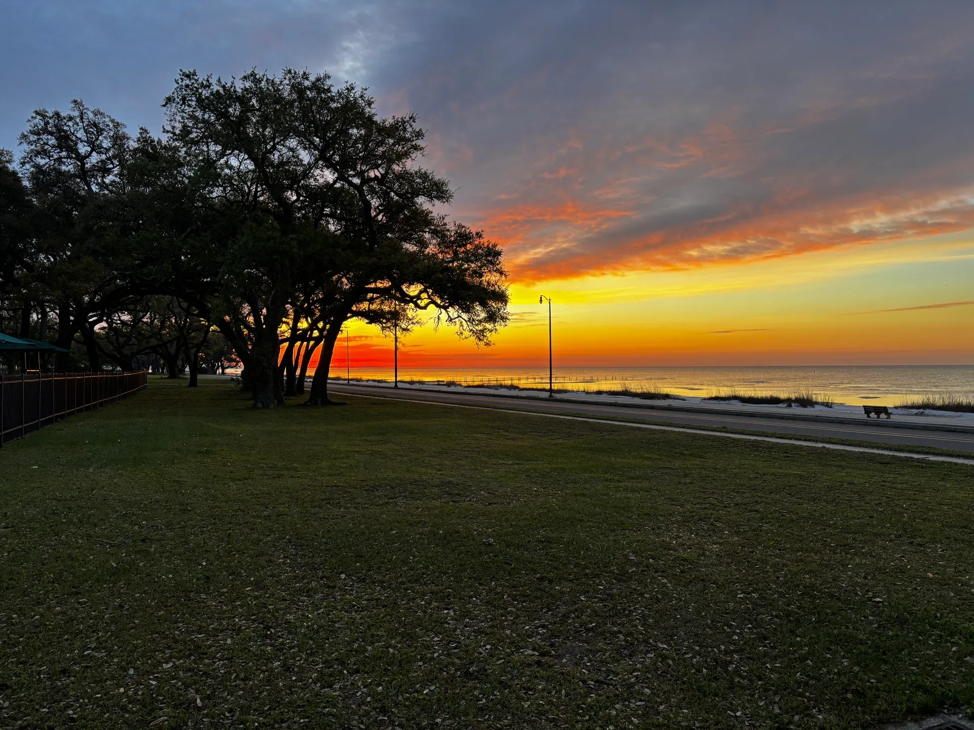 A calm sunrise over the water in Gulfport, photographed in front of the Armed Forces Retirement Home