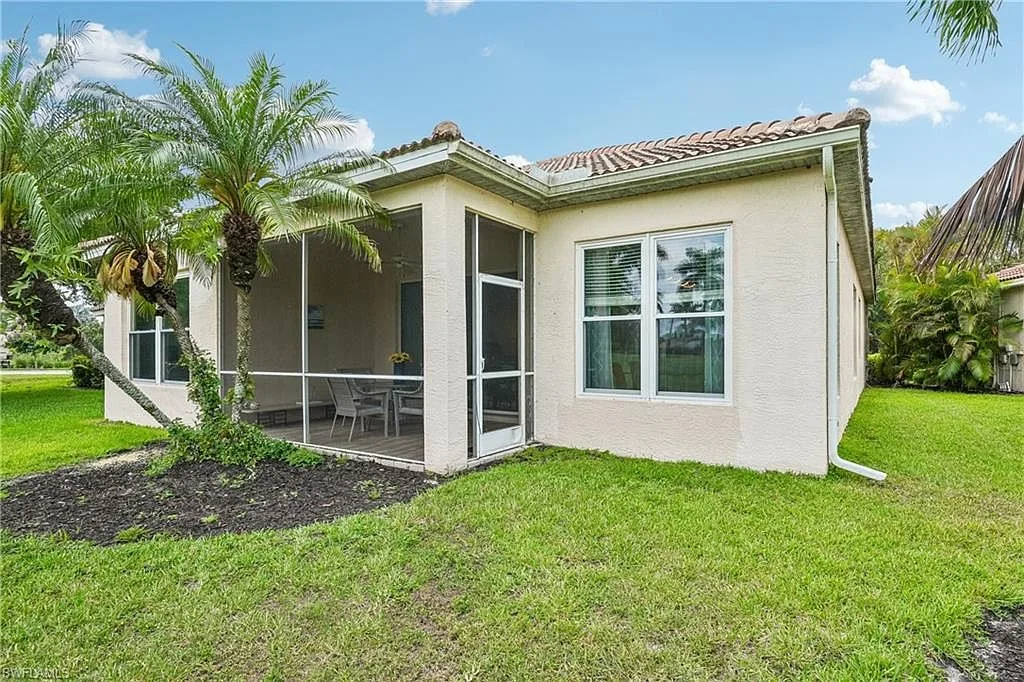 Rear exterior showing the screened-in lanai and back yard